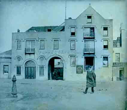 This picture, and the enlargements to the right, is from a Victorian glass plate. The exact date is not known, but it was probably as early as the 1850s, the hotel having opened in the mid-1830s. The shape of the building was unchanged for several decades, but this picture shows a low structure to the right with a sign for 'C de la Haye, hairdresser', where the Southampton Hotel was later built. There are many photographs in existence showing an oblique view of the Pomme d'Or and Southampton Hotels side by side, but head-on views of the Pomme d'Or like this are extremely rare