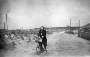 An unidentified woman cycles across Alderney