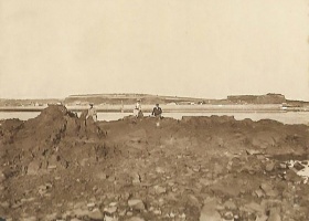 The Harbour and Fort Regent viewed from rocks below the castle