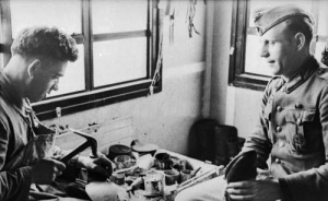 A local cobbler at work for a German soldier