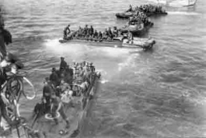 Prisoners of War being transferred from the shore in landing craft