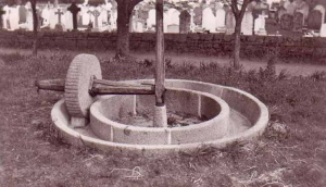 An apple crusher in an open field