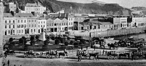 Horse-drawn carts with barrels of potatoes queue for their turn on the public weighbridge