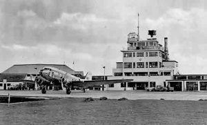 A dakota in front of the original airport building