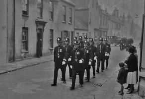 Police narch along Aquila Road in 1935 to an official parade