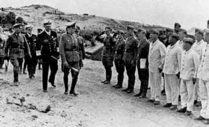 A senior officer inspects German troops