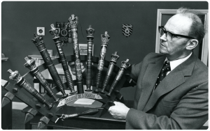 Parish secretary Cliff Robbins with a display of batons de justice at the Public Hall in the 1970s