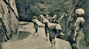 Carrying ladies through deep pools to reach Plémont's cave