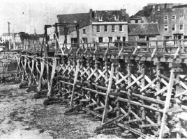 Trestles across the Old Harbour to carry railway lines during the Occupation