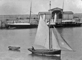 A sailing boat with a paddle steamer behind