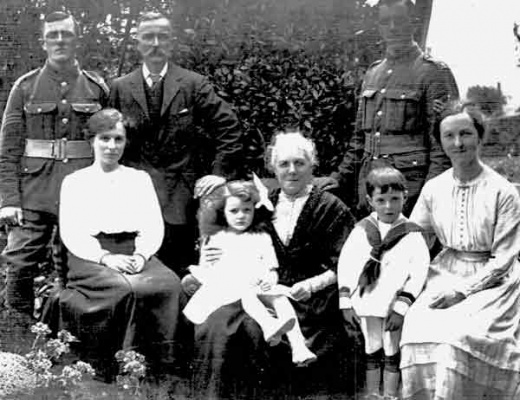 This picture shows brothers Georges and Henri Langlois, sergeants in the intelligence department of the Jersey Contingent who were able to return to Jersey briefly in 1917. They are pictured with their father Alfred and mother Victorine and sister Madeleine on the right. George Langlois' wife Berthe (nee Le Miere) is seated on the left and their children Yvonne (3) and Alfred (5) are either side of their grandmother.