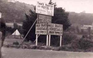 Signs for Tams Pantry on the opposite side of the road