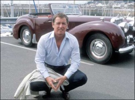 Det Sgt Jim Bergerac (John Nettles) poses in front of the famous Triumph Roadster