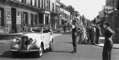 A soldier directing traffic in David Place in 1945