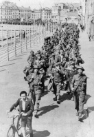 Prisoners of war on 12 May 1945 escorted by an English soldier