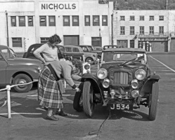 Evening Post photograph of a wheel being changed during the 1956 car rally