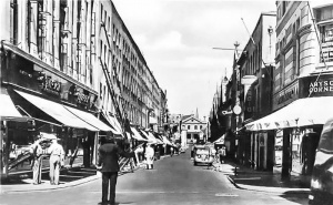 A policeman directs traffic at the junction with King Street and Queen Street