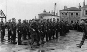 Liberating troops parade outside the Pomme d'Or Hotel