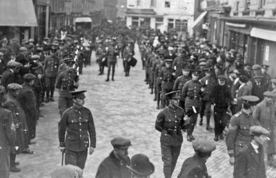 The funeral cortege and procession of Corporal Walter Cheney of the Militia’s 3rd (Town) Battalion passing through Charing Cross on 10 February 1915 having left the Parade and on its way to a service at St Mary’s and St Peter’s Church. Corporal Cheney was then carried to Almorah Cemetery for burial.