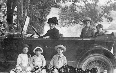 Louisa at the wheel of the car with Margaret and George behind and Dora Reg and Stanley on the running board