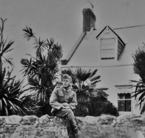 A German soldier photographed in front of an unknown Jersey cottage ...