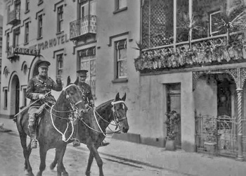 Two Militia horsemen ride past in the late 19th century