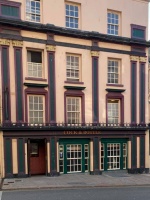 The Halkett Place entrance of the Cock and Bottle public house, formerly the Cosy Corner. Before that it was the Central Hotel. Other pictures on this page show a much plainer facade of what was a very inconspicuous building, compared with the colourful and ornate 21st century facade, which was originally created in the 19th century