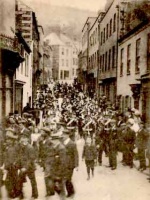A garrison band marches along Pier Road
