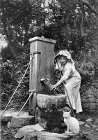 A young lady wearing an untied, pleated bonnet