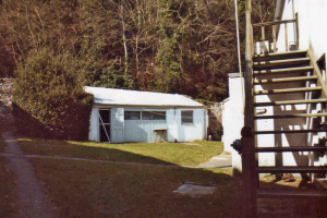 The henhouse, formerly a wood shed, believed to be the only henhouse ever given stained-glass windows (1958). These had made the Library too dark