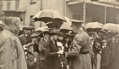 The Lieutenant Governor General Alexander Wilson presents the Military Medal in June 1917 to Louise Game on behalf of her husband Corporal Ambrose Game of 7th Battalion East Surrey Regiment. Corporal Game was wounded while fighting on the Western Front and died in a base hospital at Etaples.