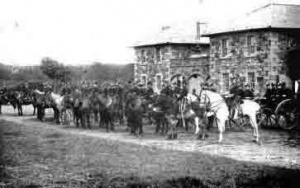 Mounted artillerymen outside their barracks