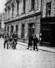 German soldiers walk past the Town Hall