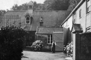 Stable Yard with Mr Boobyer. Behind him, the Harness room adjoins the stables