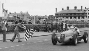 English driver Reg Parnell crosses the line