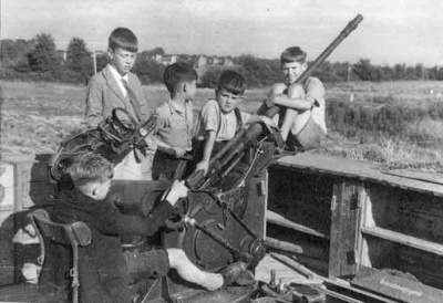 Children playing on an abandoned gun at Mont à l'Abbé