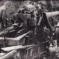 Members of Force 135 examine a large field gun at St Martin