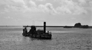 A dredger working in the small roads with Elizabeth Castle behind