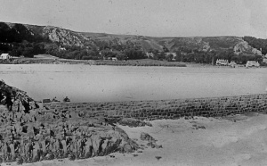 1900 - the jetty was much longer than it is now and the sea wall had not been built. Plants can be seen growing right down to the beach