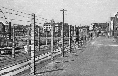 Fencing awaits removal in front of Commercial Buildings in May 1945