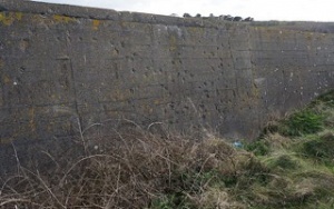 A wall full of bullet holes - evidence of executions by firing squad
