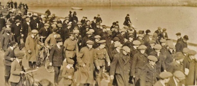 Recruits in civilian clothes march to the Harbour
